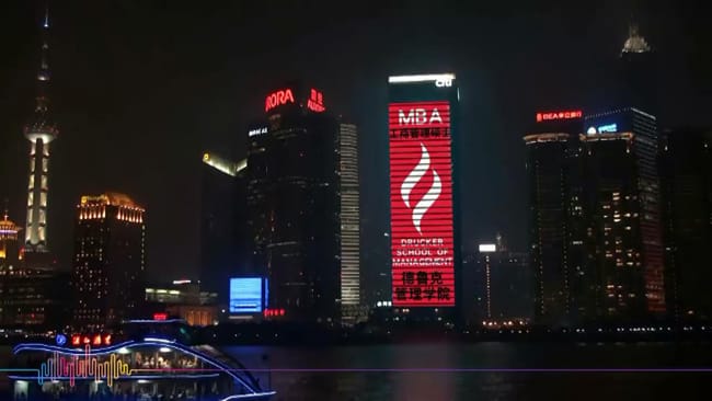 CGU flame displayed on entire building in lights in Shanghai