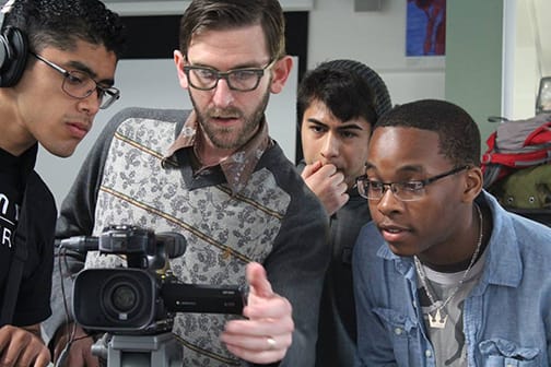 Teacher and students and video camera