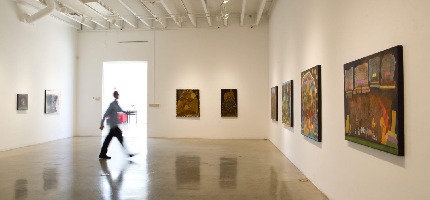 blurred image of person walking across the Art Gallery