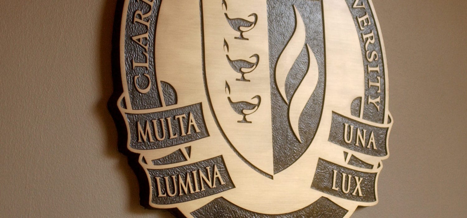 Featured area of Claremont Graduate University's emblem, featuring the motto, Multa lumina, lux una