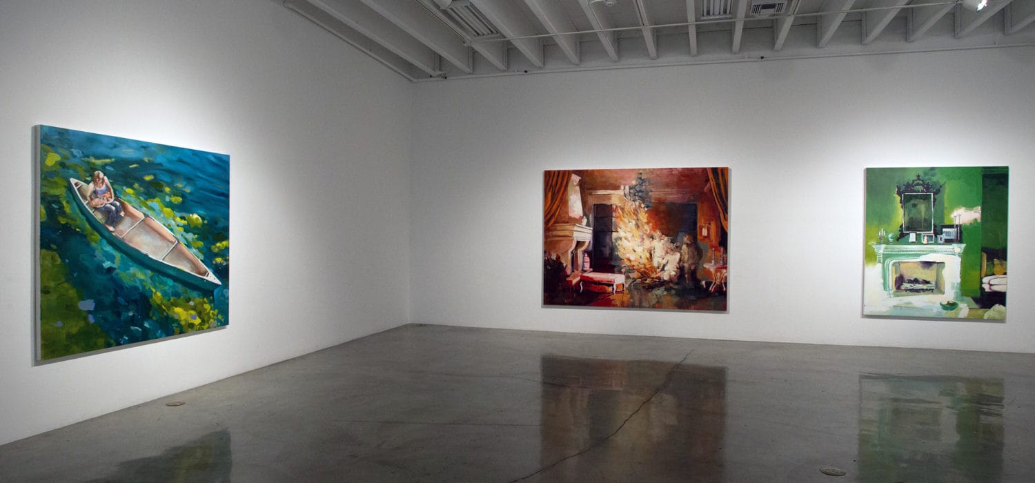 a view of two walls with 3 large paintins in art gallery