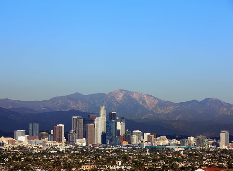 Clear sky view of the downtown LA with mountain background