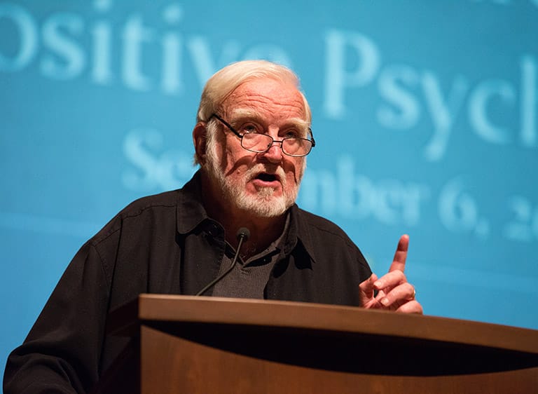 Mihaly Csikszentmihaly speaking at podium