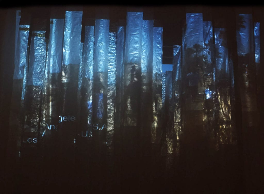Student artwork by Chaoyi Stormy Wu, silhouette of Los Angeles projected onto streams of plastic