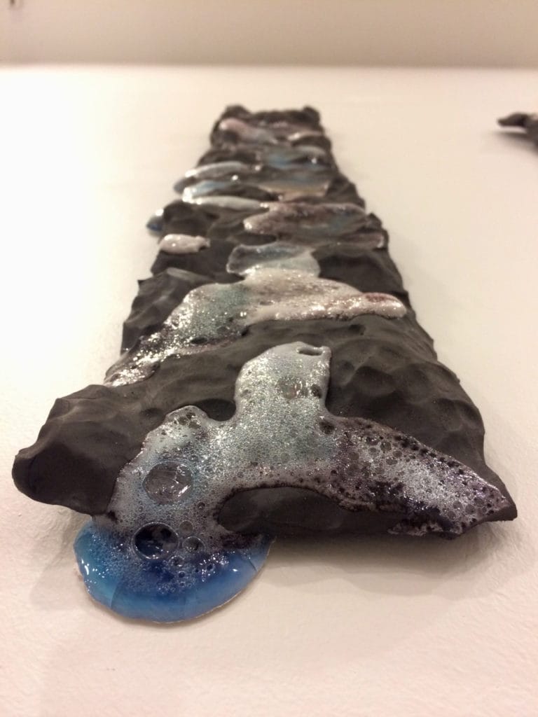 Student artwork by Diana Campuzano, black rock with bubbles