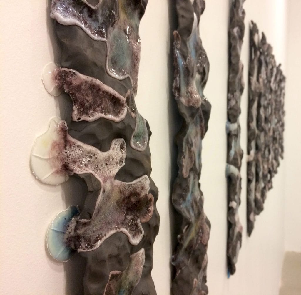 Student artwork by Diana Campuzano, strips of black rock with bubbles coming out