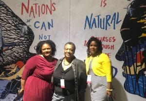 Perkins (center) with students Shante Morgan-Durisseau and Melanie Lindsay at the United State of Women Summit last spring in Los Angeles.