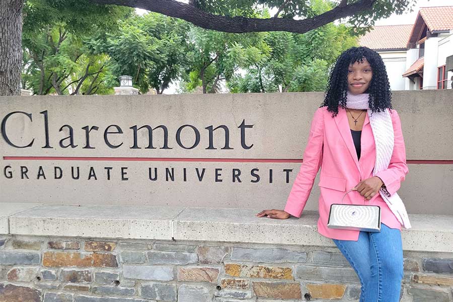 Grace Akinwande Engelberg Fellow in front of Claremont Graduate University sign