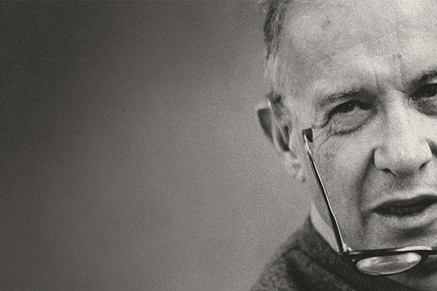 Peter Drucker speaking with his glasses coming off of his face