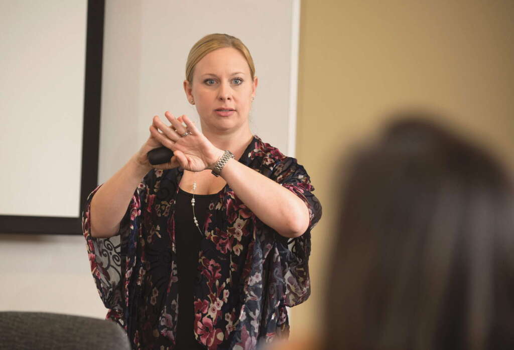 Professor Jessica DeHart teaching a classroom of students