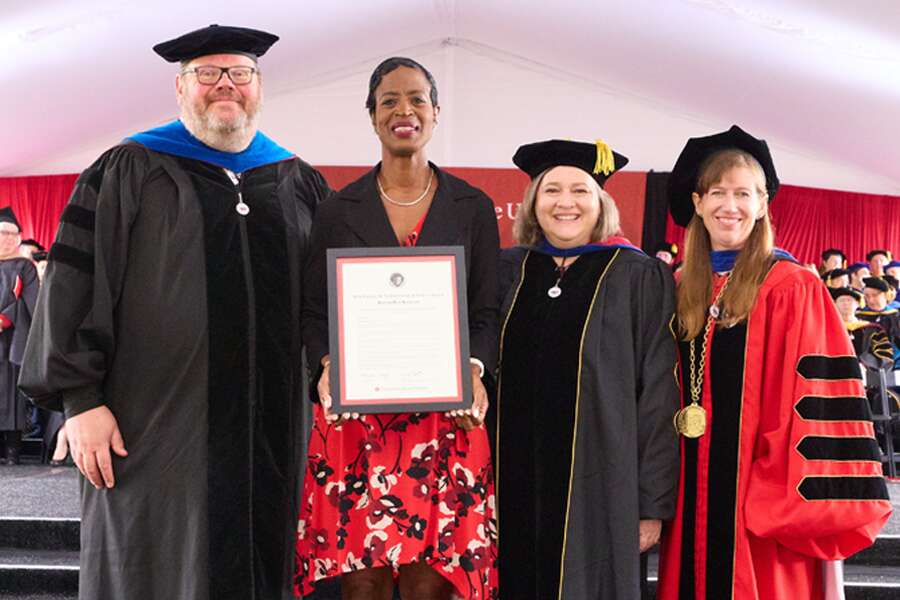 romarilyn stands with cgu faculty at commencement