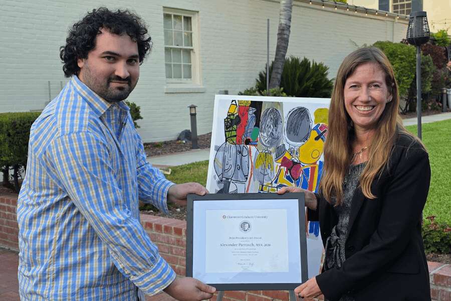 CGU MFA Grad, Alex Alex Parrasch holds the President's Art Award with CGU President, Michelle Bligh